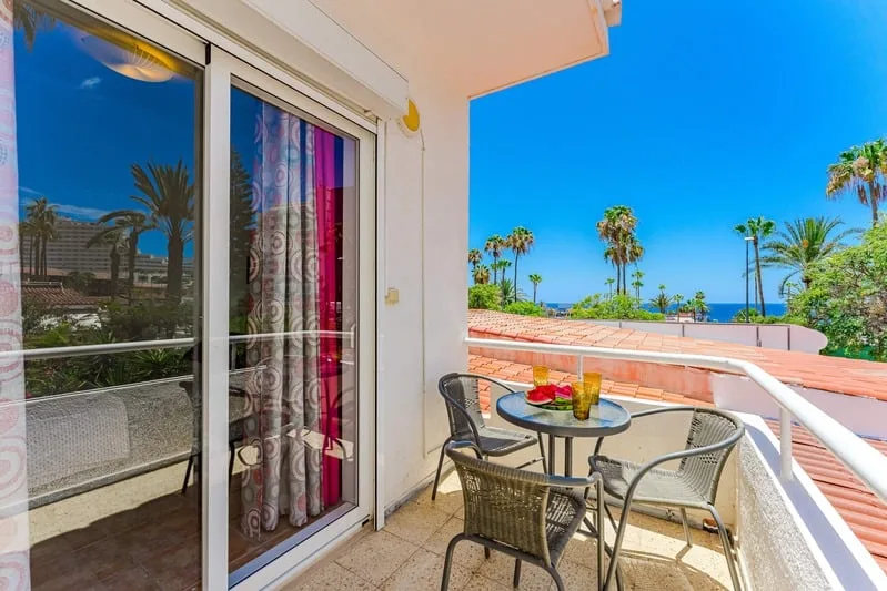 Rooftop terrace with sun loungers and ocean views in Playa de las Américas